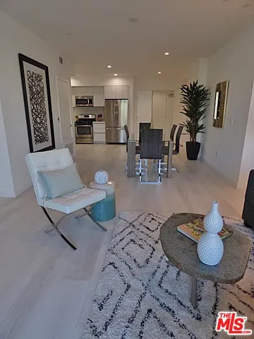 a living room with furniture and flowers