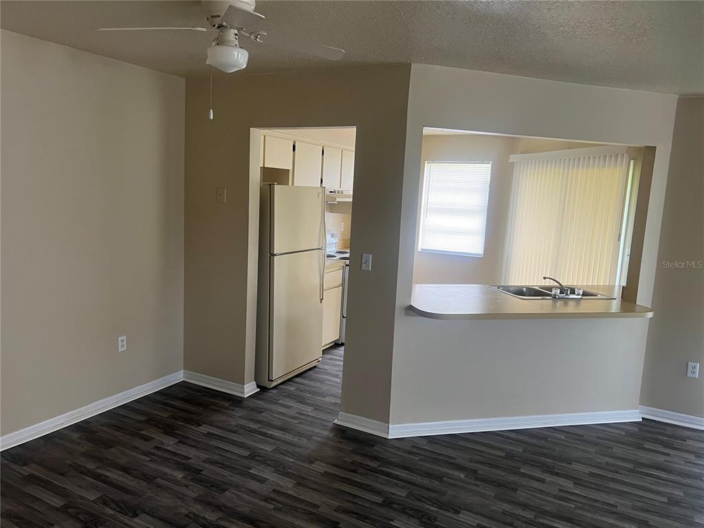 7266 Pond Circle Spring Hill, FL 34606 - Photo 13 of 15 a view of a hallway with wooden floor and a cabinet