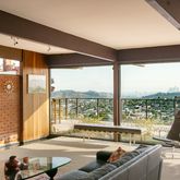 a living room with couch and a floor to ceiling window