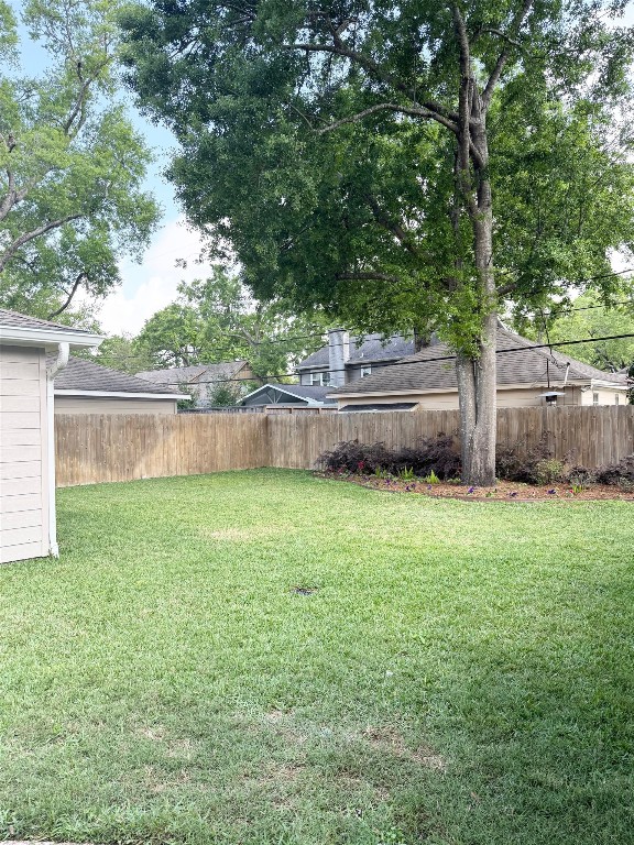 13610 Taylorcrest Road Houston, TX 77079 - Photo 22 of 22 a view of a backyard with large trees and wooden fence