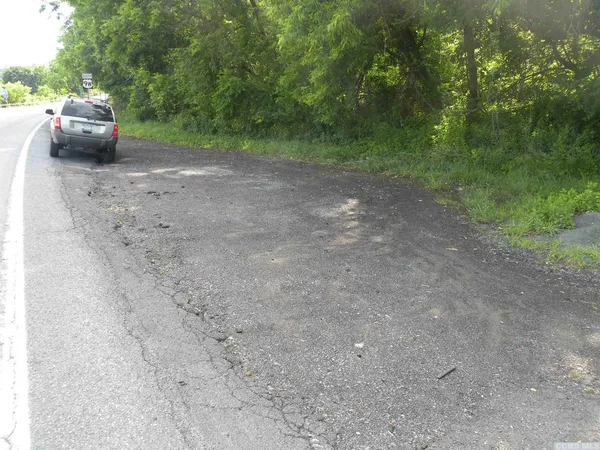 a view of the road with trees