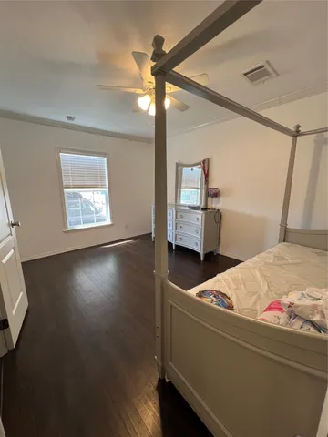 a room with a bed and wooden floor