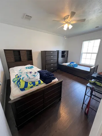 a bedroom with furniture and a wooden floor