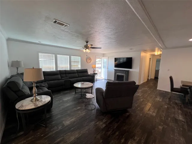 a living room with furniture fireplace and a flat screen tv