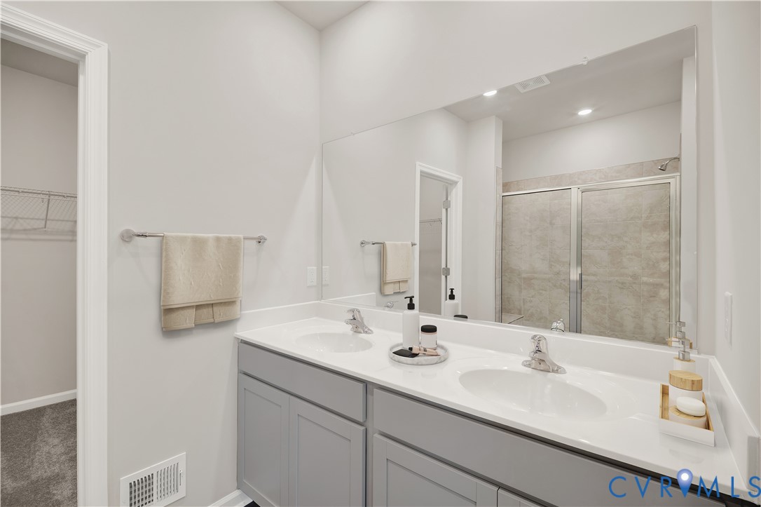 6454 Fennec Run Moseley, VA 23120 - Photo 12 of 23 a bathroom with a sink double vanity and a mirror