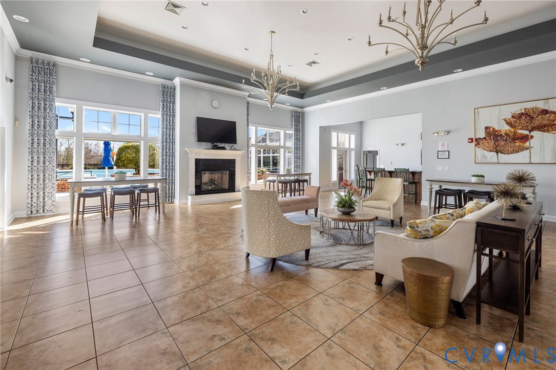 6454 Fennec Run Moseley, VA 23120 - Photo 18 of 23 a living room with furniture a flat screen tv and kitchen view