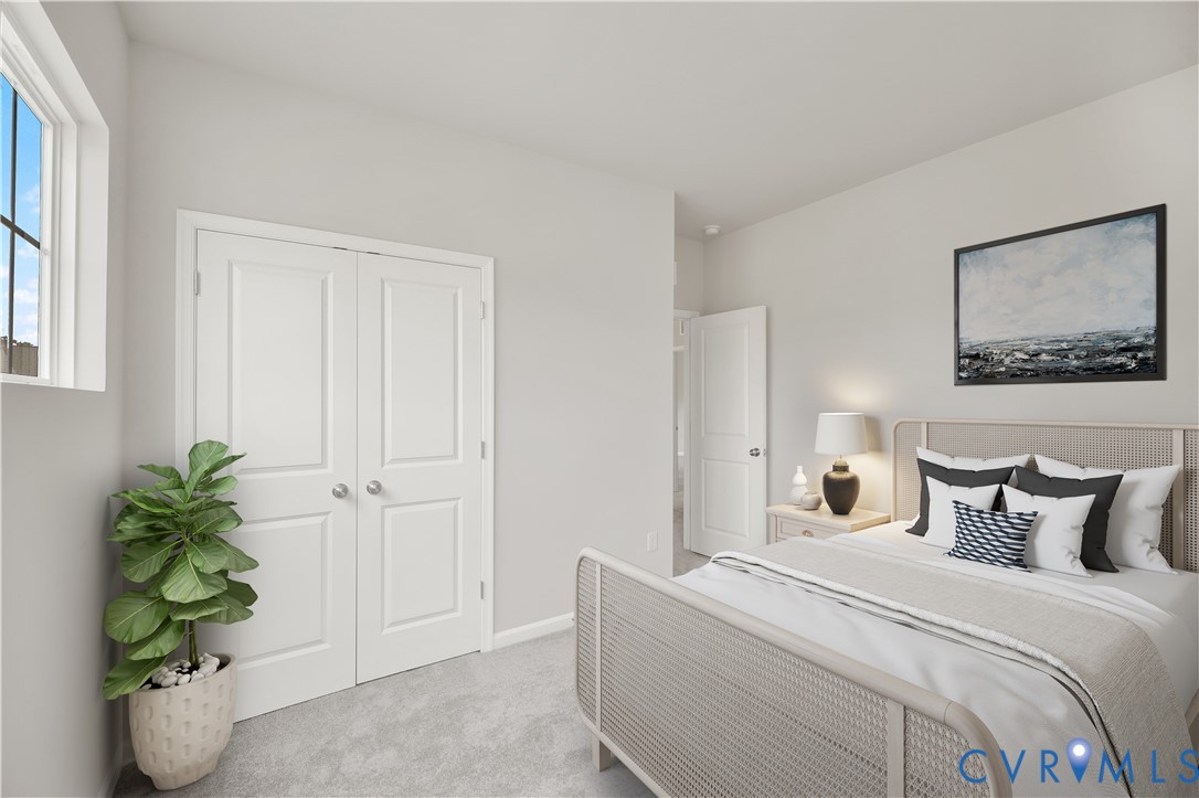 6454 Fennec Run Moseley, VA 23120 - Photo 8 of 23 a bedroom with a bed and a potted plant