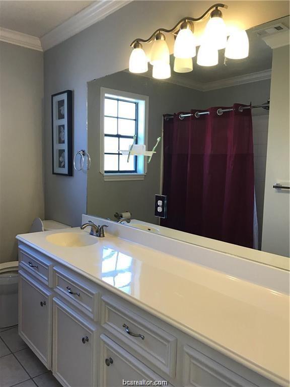 2105 Pebblebrook Lane Bryan, TX 77807 - Photo 11 of 18 a bathroom with a sink and a mirror