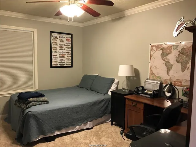 a bedroom with a bed and a lamp