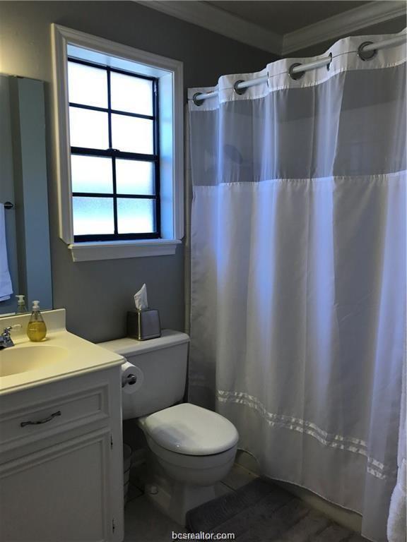 2105 Pebblebrook Lane Bryan, TX 77807 - Photo 14 of 18 a bathroom with a granite countertop sink toilet and shower