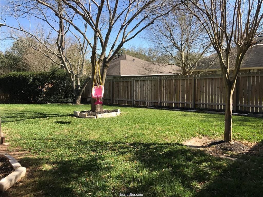 2105 Pebblebrook Lane Bryan, TX 77807 - Photo 16 of 18 a view of a backyard with table and chairs and a large tree