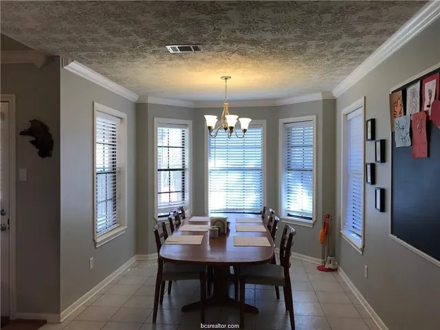 a view of a dining room with furniture and window