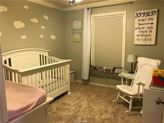 a view of a bedroom with furniture and a window