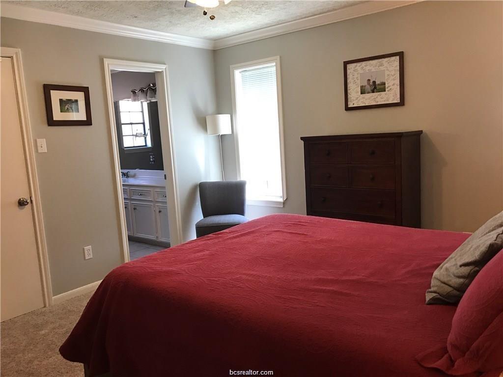 2105 Pebblebrook Lane Bryan, TX 77807 - Photo 10 of 18 a bedroom with a bed and a dresser