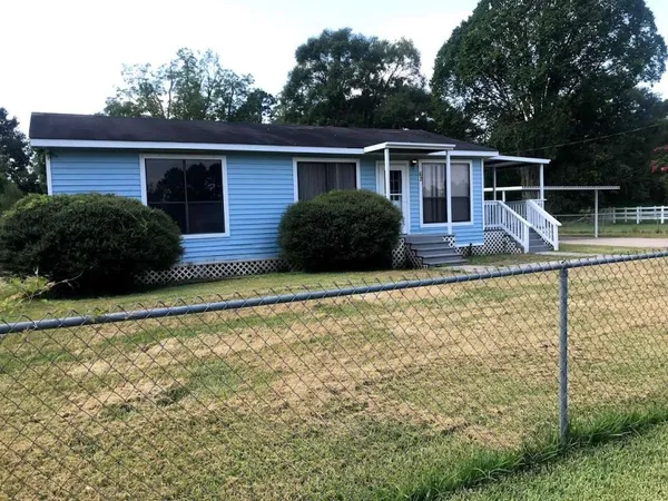 a view of house with backyard and swimming pool