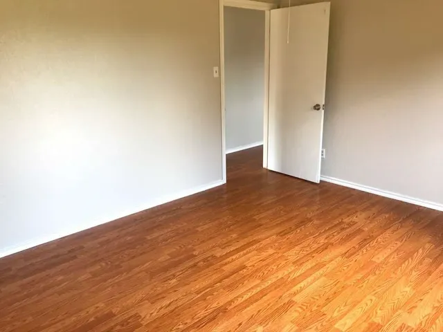 an empty room with wooden floor