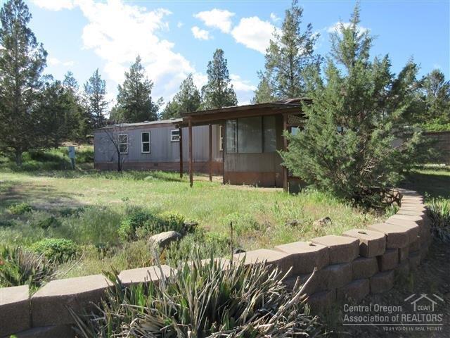 8883 Southwest Sand Ridge Road Terrebonne, OR 97760 - Photo 1 of 17 Front yard is level and has landscaping