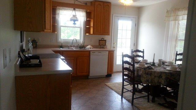 1681 Blankenship Road Goodview, VA 24095 - Photo 11 of 23 a kitchen with sink cabinets and dining table