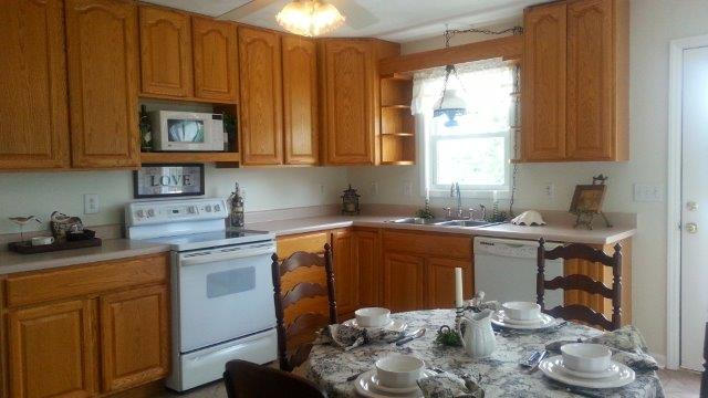 1681 Blankenship Road Goodview, VA 24095 - Photo 12 of 23 a kitchen with stainless steel appliances wooden cabinets and a stove top oven
