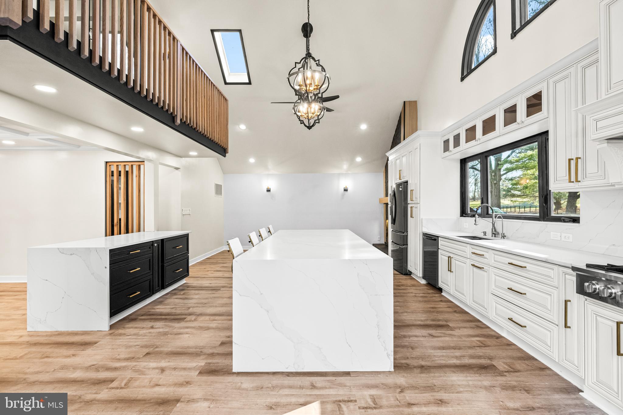12206 Cleghorn Road Cockeysville, MD 21030 - Photo 17 of 76 a large white kitchen with kitchen island a stove a sink a dining table and chairs