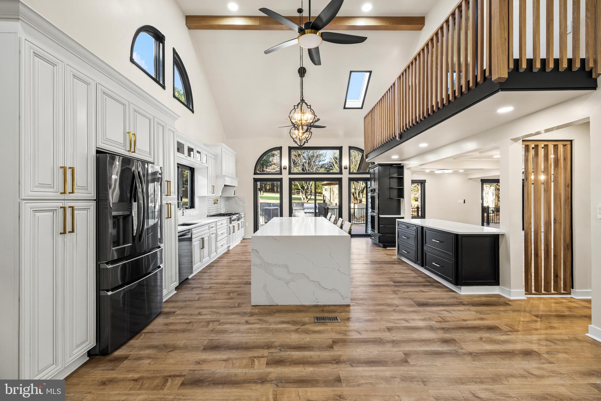 12206 Cleghorn Road Cockeysville, MD 21030 - Photo 18 of 76 a kitchen with stainless steel appliances granite countertop a refrigerator a stove and a sink with wooden floor