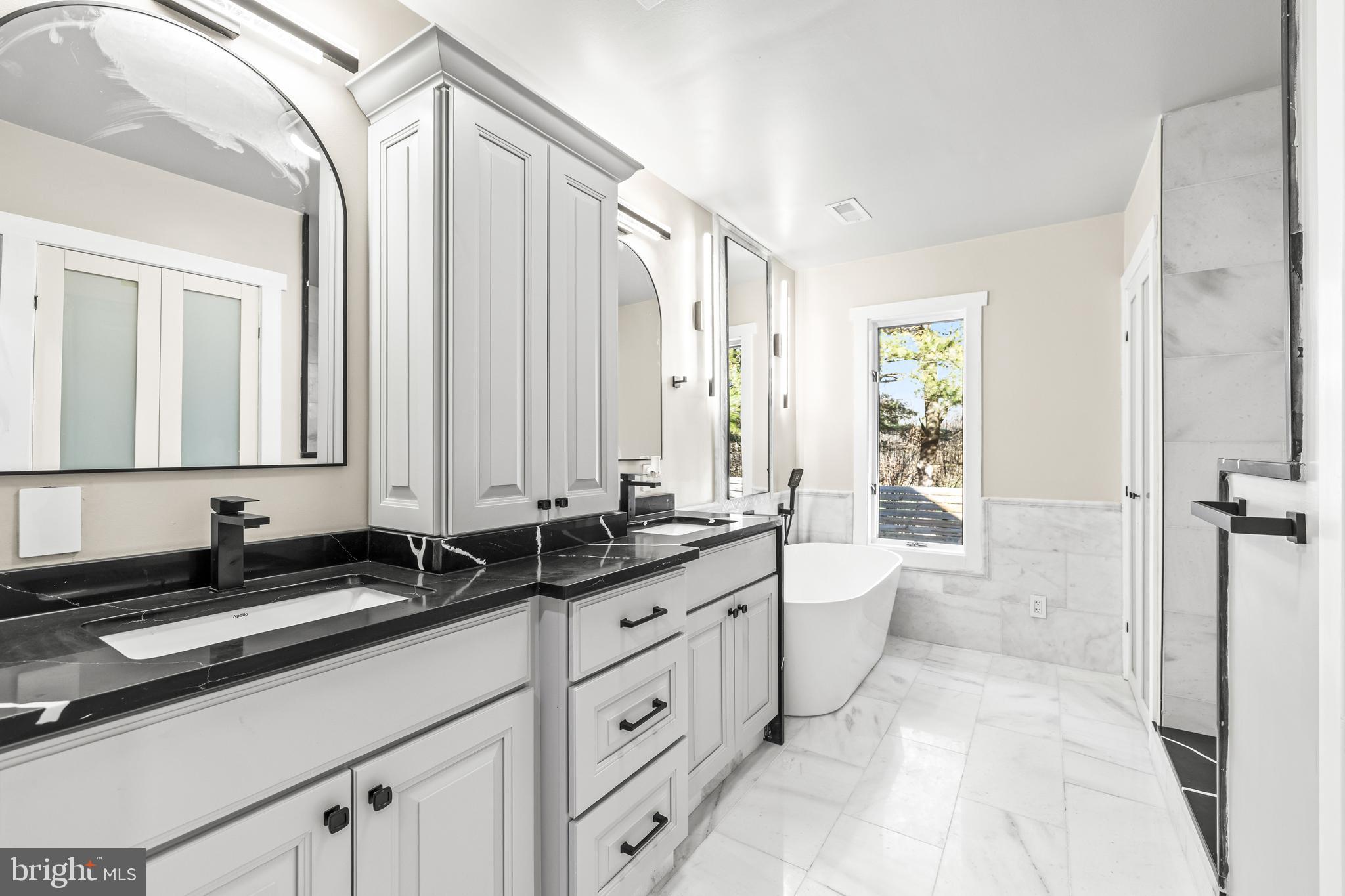 12206 Cleghorn Road Cockeysville, MD 21030 - Photo 26 of 76 a large bathroom with a double vanity sink a mirror and a bathtub
