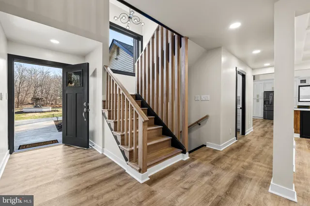 a view of staircase with white walls and a window