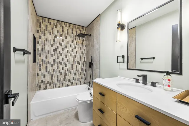 a kitchen with granite countertop a refrigerator and a sink