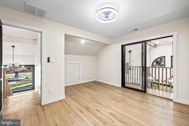a view of a balcony with wooden floor and outdoor seating
