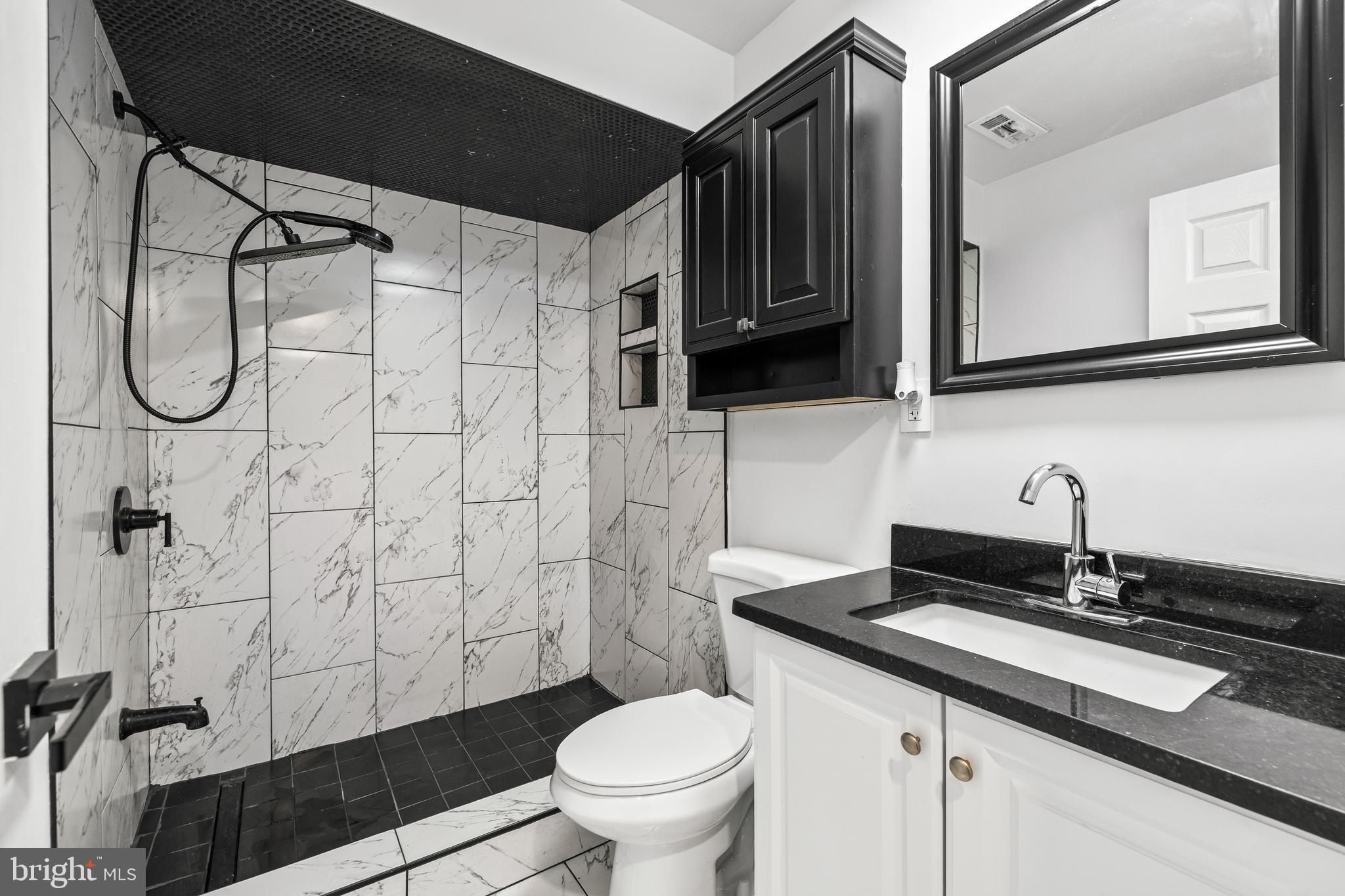 12206 Cleghorn Road Cockeysville, MD 21030 - Photo 49 of 84 a bathroom with a granite countertop sink a toilet and a mirror