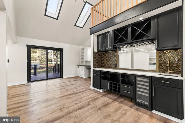 a large kitchen with a large counter top and stainless steel appliances