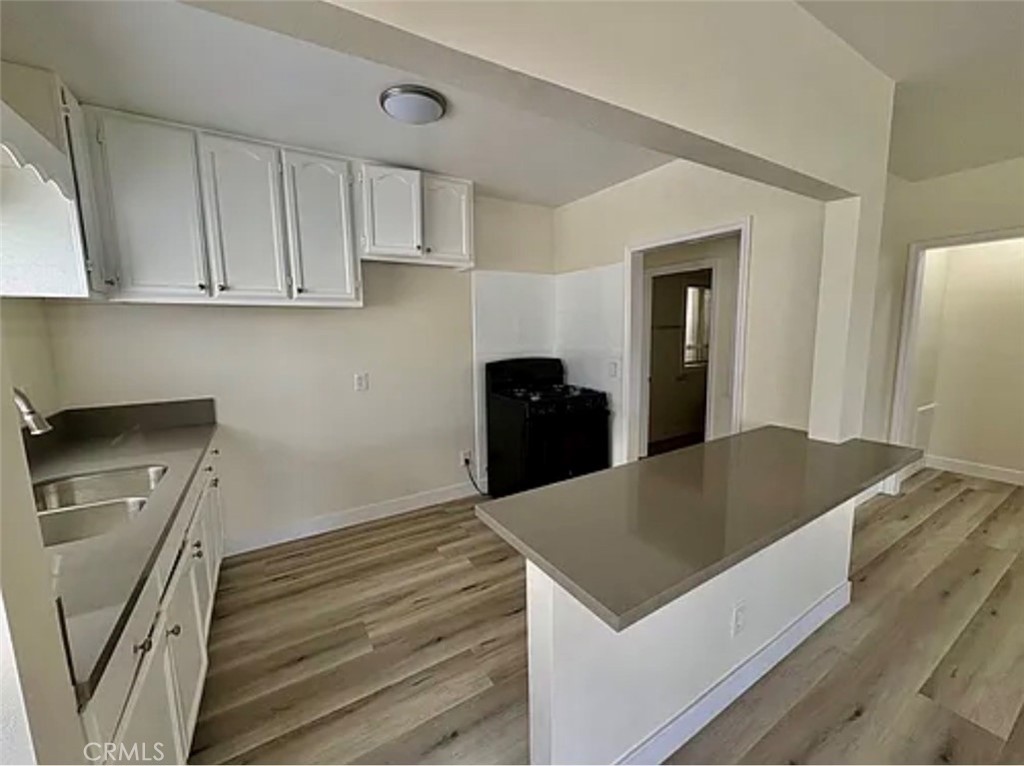 549 East 17th Street, Unit 551 Long Beach, CA 90813 - Photo 1 of 18 a kitchen with a stove a refrigerator and cabinets
