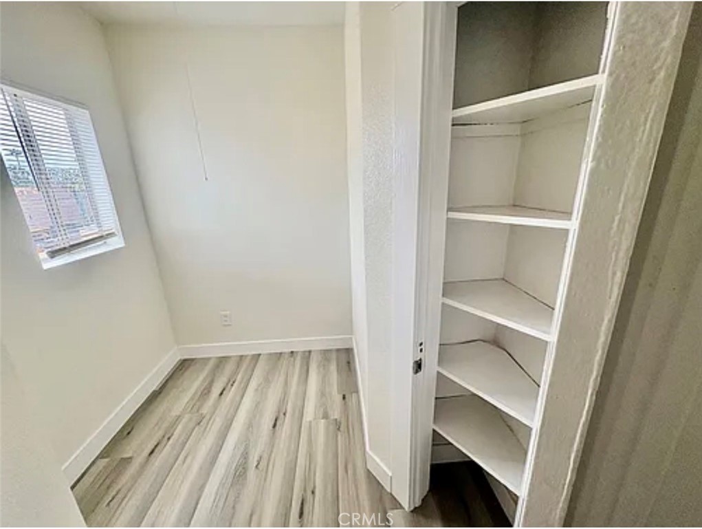 549 East 17th Street, Unit 551 Long Beach, CA 90813 - Photo 11 of 18 a view of walk in closet with empty racks