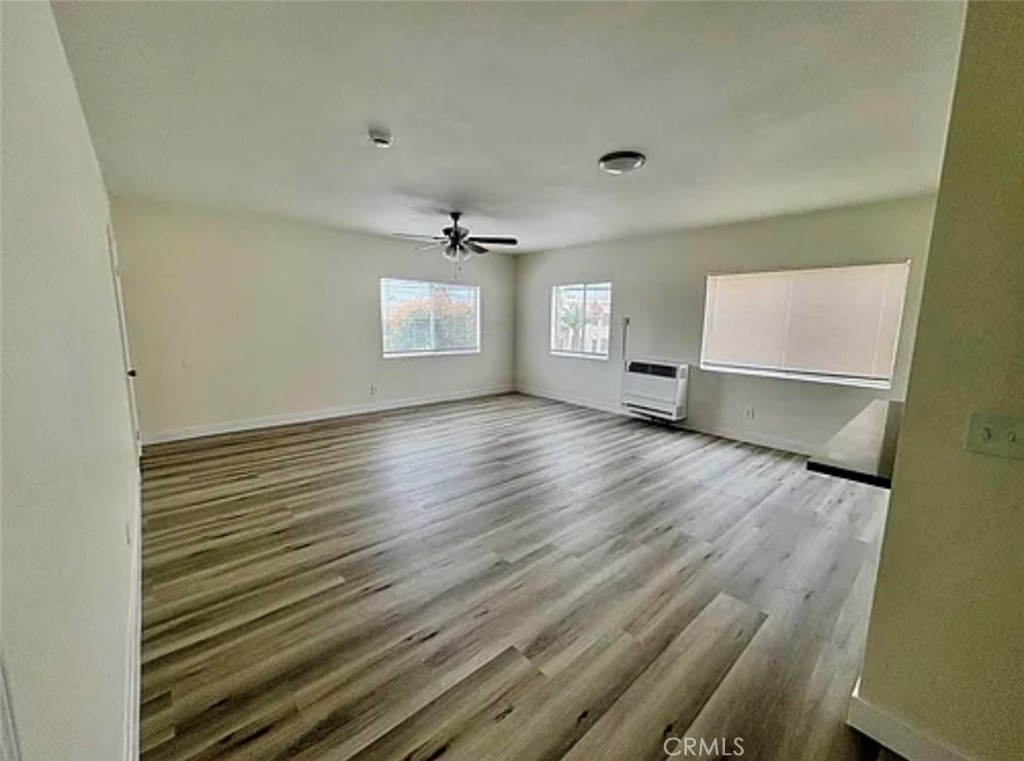 549 East 17th Street, Unit 551 Long Beach, CA 90813 - Photo 2 of 18 a view of an empty room with a window and wooden floor