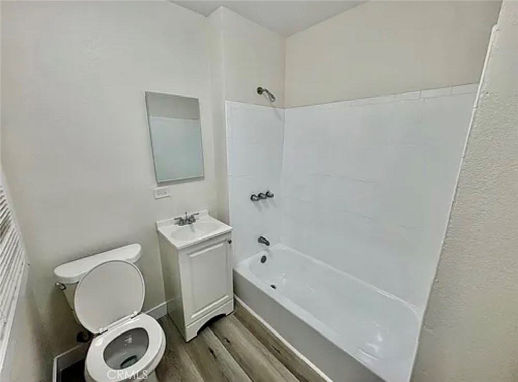 549 East 17th Street, Unit 551 Long Beach, CA 90813 - Photo 7 of 18 a bathroom with a toilet a sink and a bathtub
