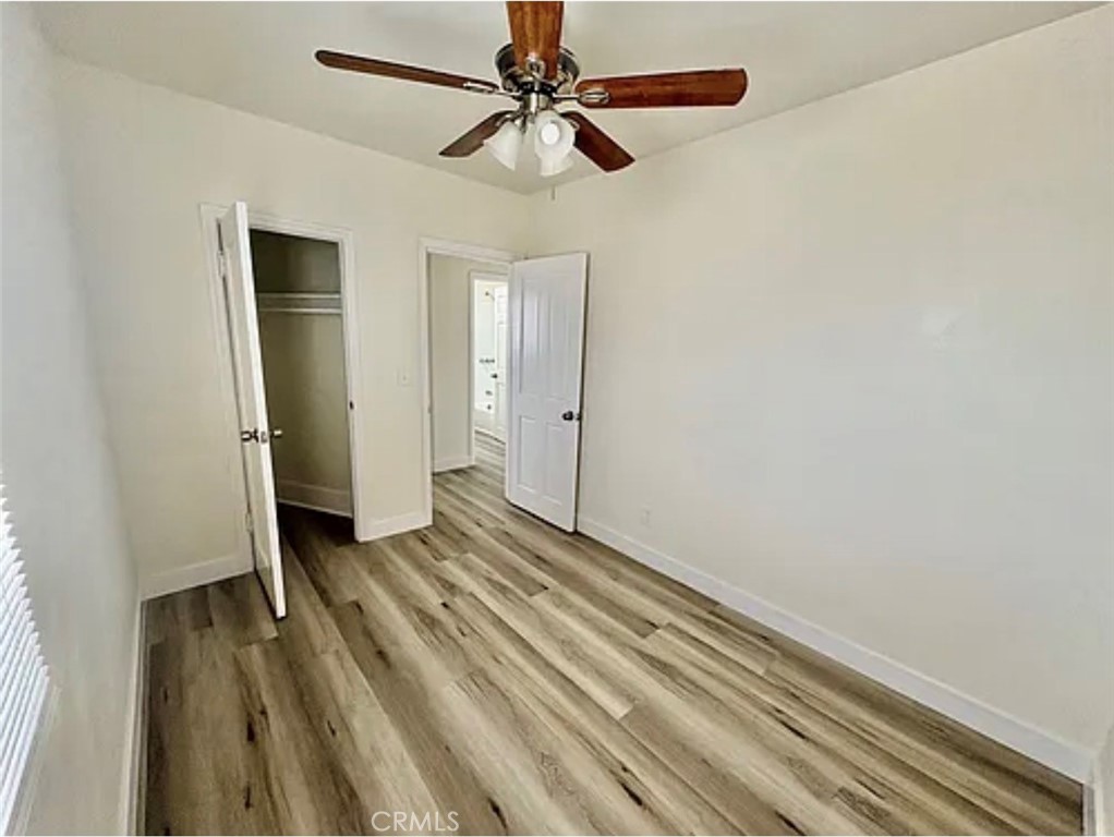 549 East 17th Street, Unit 551 Long Beach, CA 90813 - Photo 8 of 18 a view of a livingroom with a chandelier fan and wooden floor