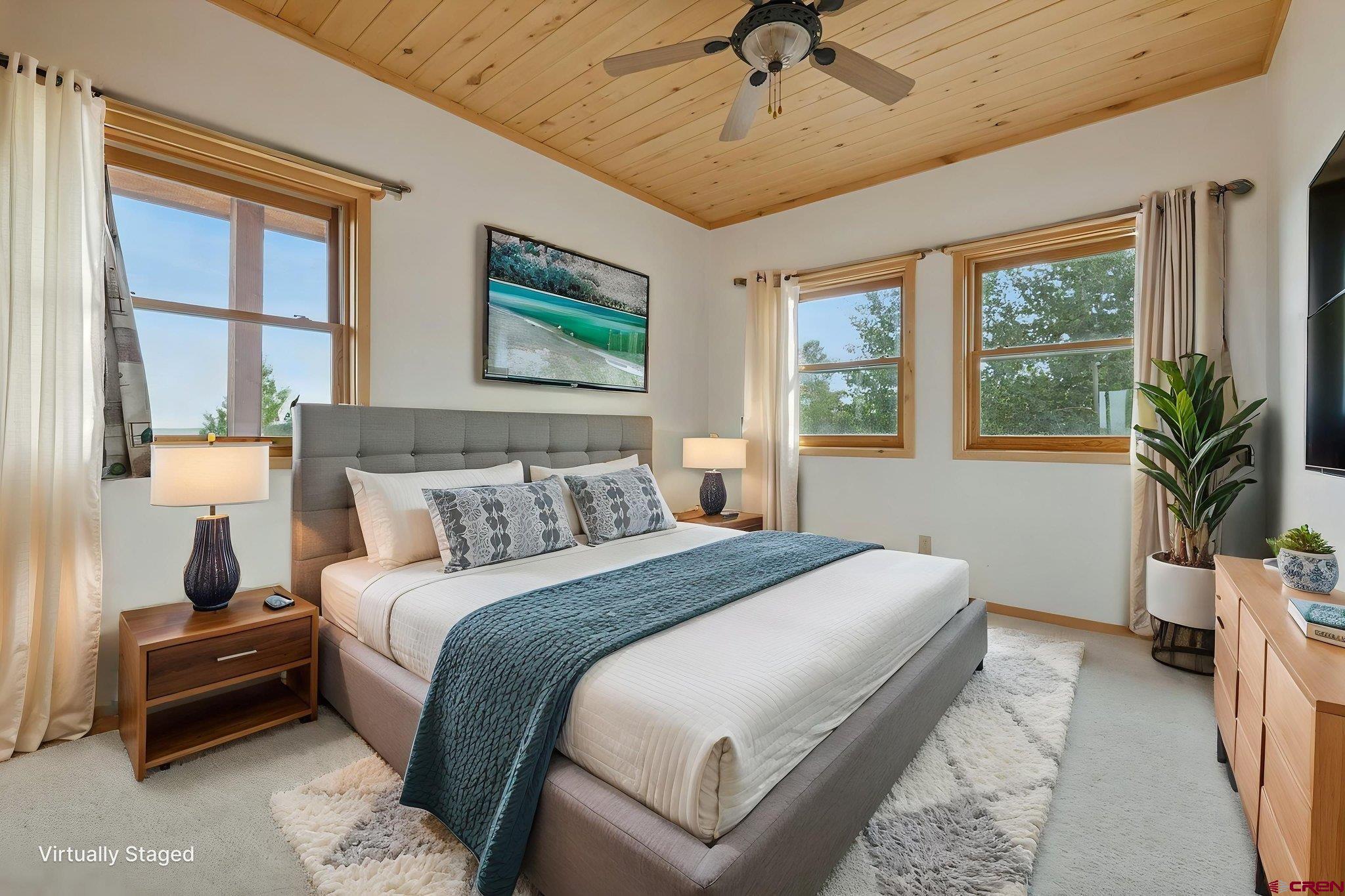 481 Far View Road Durango, CO 81303 - Photo 26 of 45 a bedroom with a balcony a bed and a chandelier