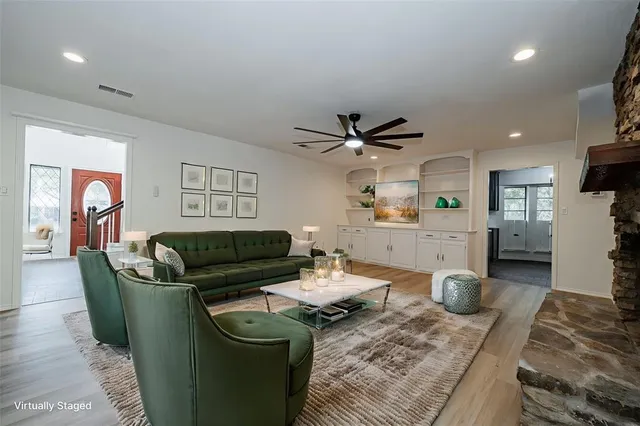 a living room with furniture and a wooden floor