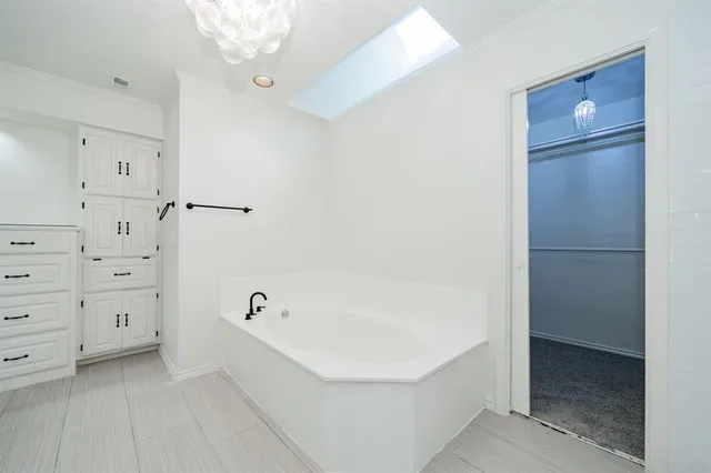 a spacious bathroom with a toilet sink and shower