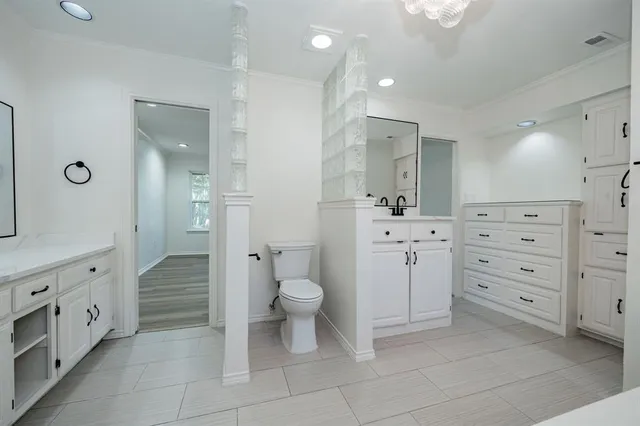 a spacious bathroom with a tub sink and mirror