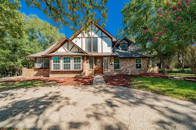 a front view of a house with a garden and patio