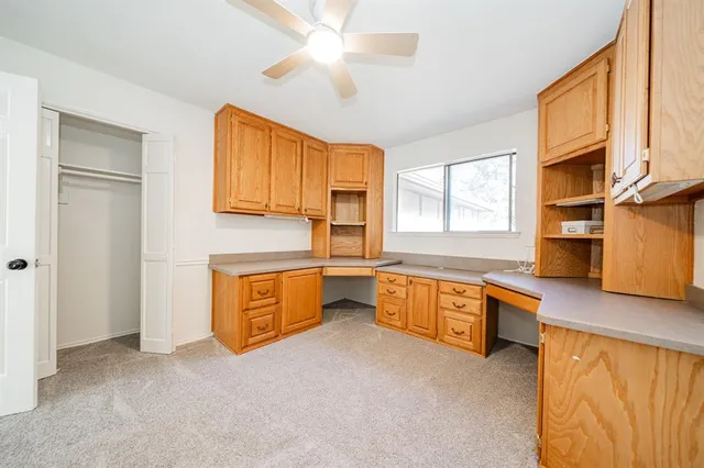 a view of a hallway with wooden floor and windows