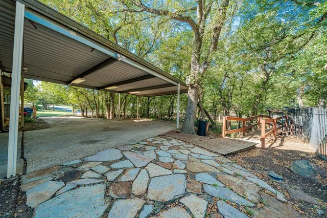 a view of house with a large tree