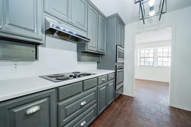 a kitchen with a sink cabinets and window