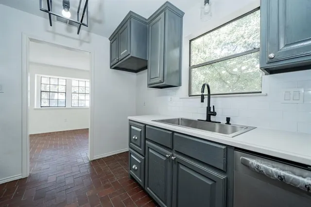a kitchen with granite countertop cabinets stainless steel appliances and wooden floor