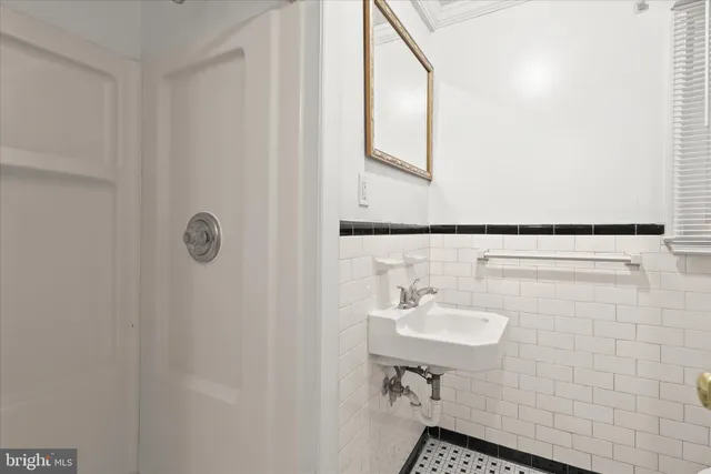 a bathroom with a sink a mirror and a shower
