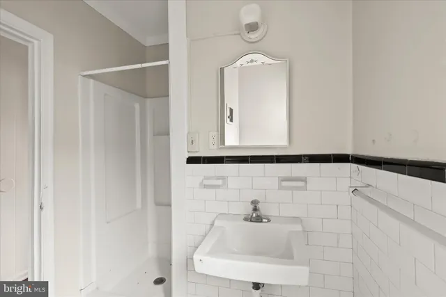 a bathroom with a sink and mirror