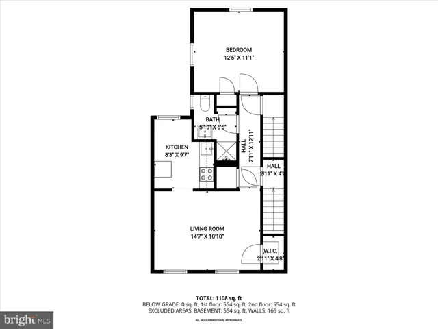 a view of a brick house with a large windows and plants