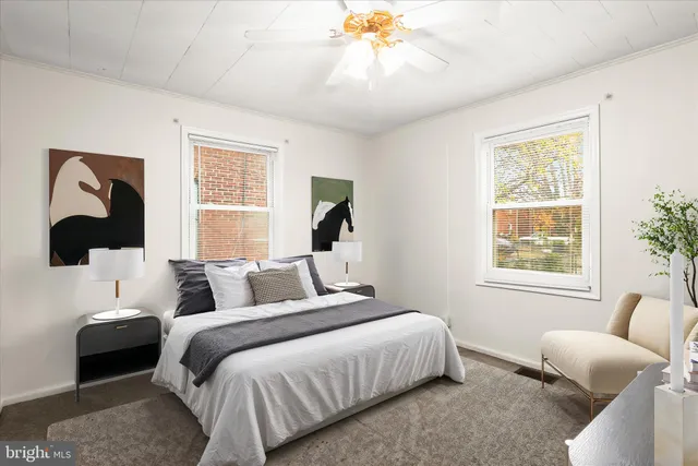 a bedroom with a bed couch and window