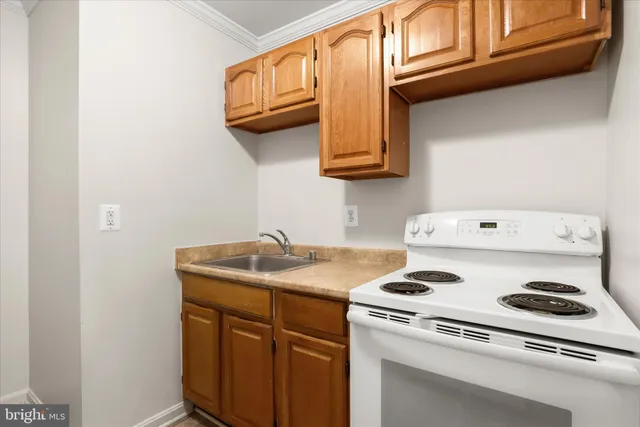 a kitchen with stainless steel appliances granite countertop a sink and a stove